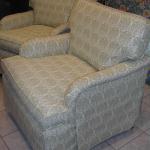 Custom upholstered english arm chairs with drop skirts.